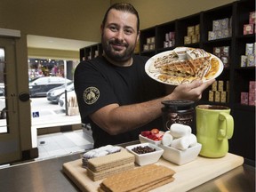 Manager Samy Kadoch with an order of Sharing Sharing for Two or More, a chocolate extravaganza that includes a quarter of chocolate pizza, served hot, a banana-split waffle, brownie bits, chocolate wafers, chocolate-coated cereal, chocolate-covered ice cream, marshmallows for grilling at your table, and a milk chocolate fondue for dipping.