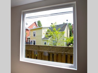 A window in the dining room perfectly frames the farmhouse around the corner that provided the inspiration for the home’s design.