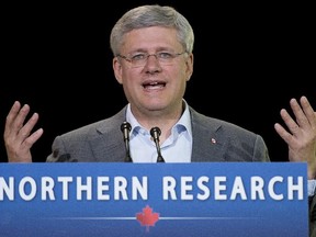 Canadian Prime Minister Stephen Harper responds to questions after making an announcement at the Yukon college in Whitehorse, Thursday August 21, 2014.
