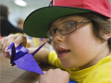 Eight-year-old Jacob is one of the Spy Camp Kids at the Diefenbunker in Carp are folding paper cranes in an Origami class to send to Japan. They hope is to make between 600 and 1,000 cranes.