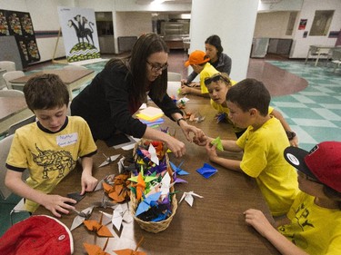 Guide Marcelina Lassak (glasses) leads the Spy Camp Kids at the Diefenbunker in Carp in folding paper cranes in an Origami class to send to Japan. They hope is to make between 600 and 1,000 cranes.