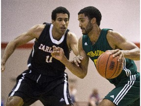 The Ravens' Thomas Scrubb defends against the Catamounts' Hector Harold on Tuesday night at the Ravens' Nest.