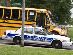 Shuttle buses run along Lakeside Ave. at Queen Elizabeth Driveway Friday, carrying fans to TD Place for the Redblacks game against the Edmonton Eskimos Friday August 15, 2014.