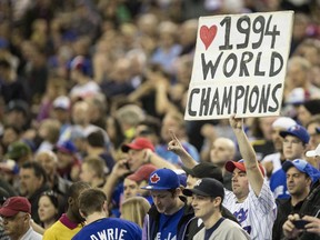 A fan shows his appreciation as members of the 1994 Montreal Expos are honored before an exhibition baseball game between the Toronto Blue Jays and the New York Mets Saturday, March 29, 2014, in Montreal.