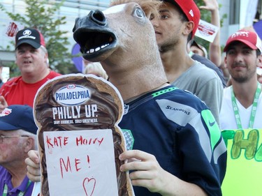 A fan wears a rubber horse head during a family friendly event featuring TSN announcers during the Ottawa Redblacks and Calgary Stampeders match at TD Place in Ottawa on August 24, 2014.