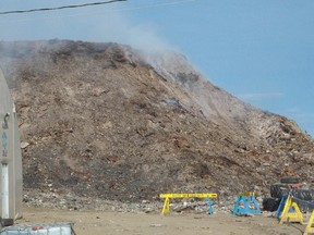 A fire smoulders at a dump in Iqaluit, Nunavut, on July 16, 2014. Although no flames are visible, the stubborn dump fire has been smouldering since May 20.