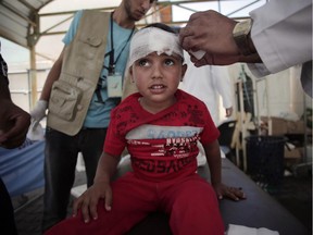 A Palestinian boy injured in an Israeli strike receives treatment in the Kuwaiti hospital in Rafah refugee camp, southern Gaza Strip, Sunday, Aug. 3, 2014.