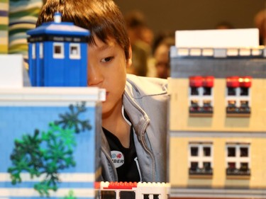Alexi Raymond Tsai, 6, gets a closer look at the intricate lego buildings during the Ottawa Maker Faire being held at the Canada Science and Technology Museum on August 17, 2014.
