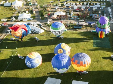 Hot air balloons are inflated before a morning flight over Gatineau Friday, August 29, 2014.