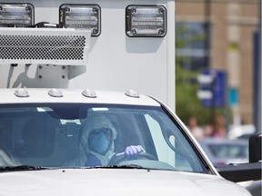 An ambulance transporting Nancy Writebol, an American missionary stricken with Ebola, arrives at Emory University Hospital, Tuesday, Aug. 5, 2014, in Atlanta. Writebol is expected to be admitted to Emory University Hospital on Tuesday, where she will join another U.S. aid worker, Dr. Kent Brantly, in a special isolation unit.