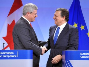 European Commission President Jose Manuel Barroso (R) shakes hand with Prime Minister Stephen Harper following a signing ceremony last fall for the free-trade accord.