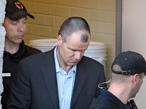 This 2010 file phone shows Russell Williams being escorted from the Belleville Superior Court under heavy armed guard and in handcuffs after pleading guilty to murder. Williams, the former commander of Canadian Forces Base Trenton, was charged with two counts of first-degree murder in the deaths of two eastern Ontario women, Cpl. Marie-France Comeau, 38, and Jessica Lloyd, 27. In addition, he was also charged with sexually assaulting two other women and had 82 charges related to break-ins and lingerie thefts in Ottawa, Belleville and the nearby town of Tweed. (Julie Oliver/Ottawa Citizen)