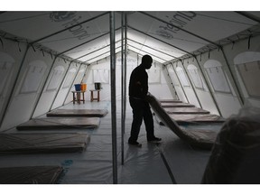 MONROVIA, LIBERIA - AUGUST 17:  Workers prepare the new Doctors Without Borders (MSF), Ebola treatment center on August 17, 2014 near Monrovia, Liberia. The facility initially has 120 beds, making it the largest such center for Ebola treatment and isolation in history, and MSF plans to expand it to a 350-bed capacity. Tents at the center were provided by UNICEF. The Ebola epidemic has killed more than 1,000 people in four African countries, and Liberia now has had more deaths than any other country.