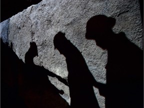 Images of WWI soldiers are projected onto a recreated trench during a photocall to launch the Imperial War Museum's new First World War Galleries Atrium in London, on July 16, 2014.