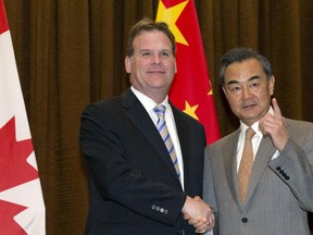 Foreign Affairs Minister John Baird shakes hands with Chinese Foreign Minister Wang Yi before a meeting at the Foreign Ministry on July 29, 2014 in Beijing, China. Baird traveled to China for the meeting at the invitation of Foreign Minister Yi.