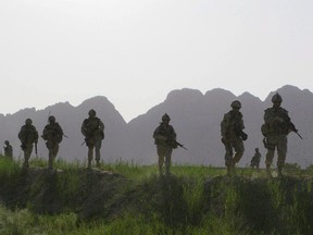 Canadian soldiers patrol an area in the Dand district of southern Afghanistan on Sunday, June 7, 2009.