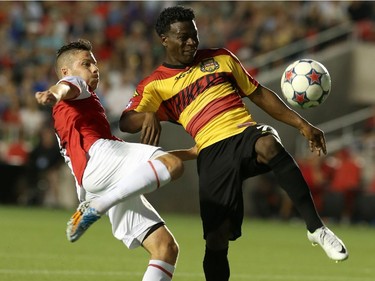 Carl Haworth #17 of the Ottawa Fury battles against Walter Ramirez #73 of the Fort Lauderdale Strikers during an NASL match at TD Place in Ottawa on August 9, 2014.