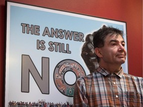 Chief Francis Laceese, of the Tl'esqox First Nation, stands in front of a poster showing opposition to the Enbridge Northern Gateway Pipeline after the Supreme Court of Canada ruled in favour of the Tsilhqot'in First Nation, granting it land title to 438,000-hectares of land.