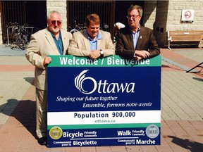 From left, Councillors Allan Hubley and Peter Hume join Mayor Jim Watson to unveil the new Ottawa sign at City Hall on Friday, Aug. 8, 2014.