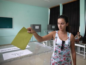 A Turkish citizen casts her vote for Ankara's presidential elections on August 1, 2014  at a school, turned polling station in the Turkish-controlled north of the Cypriot capital Nicosia. Turkey's August 10 election, in which Prime Minister Recep Tayyip Erdogan is seeking to become head of state, marks the first time the Turkish president will be chosen by popular vote, and the first time poll booths have been set up abroad.