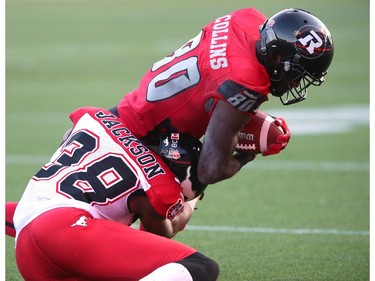 Dobson Collins #80 of the Ottawa Redblacks is tackled by Buddy Jackson #38 of the Calgary Stampeders during a CFL match at TD Place in Ottawa on August 24, 2014.