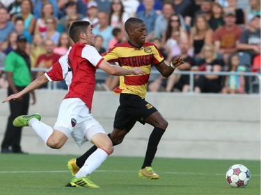 Drew Beckie #4 of the Ottawa Fury chases after Fafà Picault #11 of the Fort Lauderdale Strikers during an NASL match at TD Place in Ottawa on August 9, 2014.