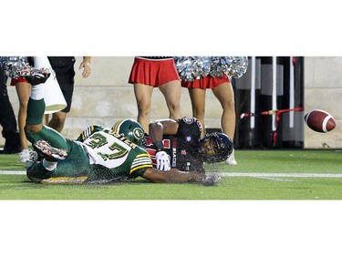 Players slide on the field during the Ottawa Redblacks Friday night matchup against the Edmonton Eskimos at TD Place in Ottawa, August 15, 2014.