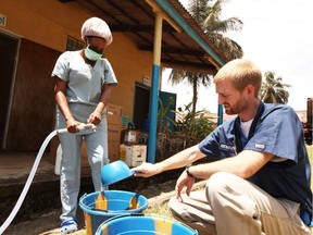 In this handout provided by Samaritan's Purse, Dr. Kent Brantly, one of the two Americans who contracted Ebola, works at an Ebola isolation ward at a mission hospital outside of Monrovia, Liberia.