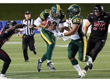 Edmonton's QB Mike Reilly runs the ball in the final minutes of the game during the Ottawa Redblacks Friday night matchup against the Edmonton Eskimos at TD Place in Ottawa, August 15, 2014.