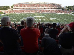 Fans cheer on the Ottawa Redblacks as they take on the Toronto Argonauts in their first ever home game during first half CFL action at TD Place in Ottawa on Friday, July 18, 2014.