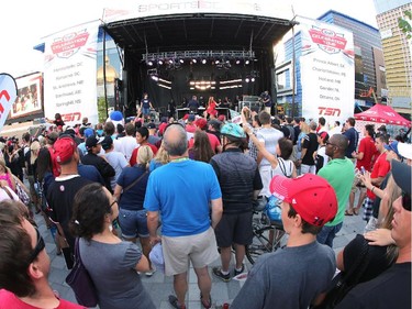 Fans gather on the plaza during a family friendly event featuring TSN announcers during the Ottawa Redblacks and Calgary Stampeders match at TD Place in Ottawa on August 24, 2014.