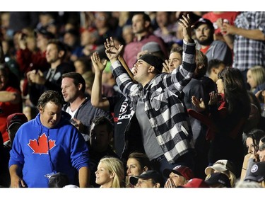 Fans react to the tackle where Ottawa lost the ball in the dying minutes of the game during the Ottawa Redblacks Friday night matchup against the Edmonton Eskimos at TD Place in Ottawa, August 15, 2014.