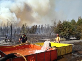 Firefighters used brush trucks and ATVs to battle a massive brush fire made worse by Ottawa's dry conditions in 2012. Firefighters were sent to the area near the Lime Kiln Trail.