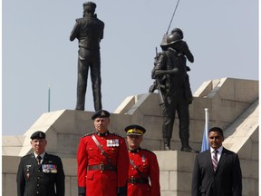 Former and current Canadian Peacekeepers stand at the National Peacekeepers Day Ceremony at the Peacekeeping Monument in Ottawa on Sunday, August 10, 2014.