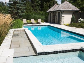 Limestone and plants with a tropical feel provide a framework for an inviting pool in this Rockcliffe Park backyard designed by landscape architect John K. Szczepaniak.
