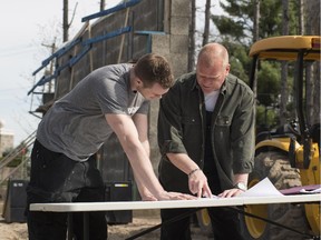 Celebrity contractor Mike Holmes shows his son, Mike, Jr., the blueprints for his dream garage. Holmes has given the reins to his son, who will build the garage on the new HGTV show Mike’s Ultimate Garage, which airs Sept. 1.