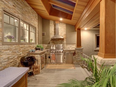 The back porch of this Alta Vista home renovated by Herb Lagois features an outdoor kitchen, warm cedar ceilings and skylights to bring natural light into the kitchen.