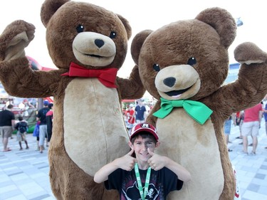 Gavin Hughes, 6, hams it up in front of the Kraft peanut butter bears during a family friendly event during the Ottawa Redblacks and Calgary Stampeders match at TD Place in Ottawa on August 24, 2014.