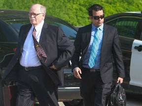 Elections Canada investigator Allan Mathews, left, and Chris Crawford, right, Conservative staffer and witness for the prosecution, arrive  at the courthouse in Guelph Ontario for the first day of the Robocalls trial on June 2, 2014.