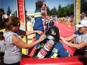 Hamilton Fire Department's Justin Couperus celebrates a time of 1:15:120 for first place in the individual competition at the Firefit Challenge in Orleans on Saturday, August 23, 2014.