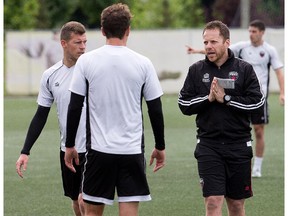 Head coach Marc Dos Santos makes a point to his players as the Ottawa Fury practise at Algonquin College on Aug. 15, 2014.