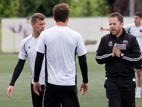 Fury head coach Marc Dos Santos makes a point to his players during practice.