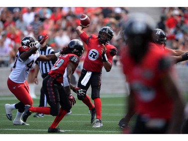 Ottawa Redblacks' Henry Burris lines up a pass as he takes on the Calgary Stampeders during CFL action in Ottawa on Sunday, Aug. 24, 2014.