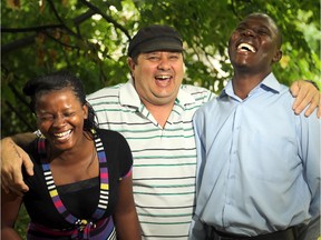 Herbert Stuemer (centre) shares a laugh with Dr. George Ouma and his new wife, Florence Mbandi, at his Ottawa home Wednesday, August 13, 2014. The couple made Ottawa their honeymoon destination to thank Stuemer and his Northern Magic charity, which enabled him to attend medical school as a young man in Kenya.