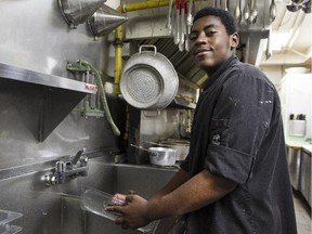 High-school student Daniel Kachuki washes dishes at Lapointe's fish restaurant in Westboro.