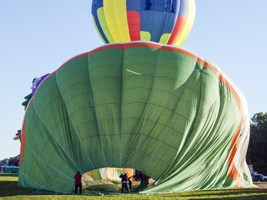 Hot air balloons are inflated before a morning flight over Gatineau Friday, August 29, 2014.