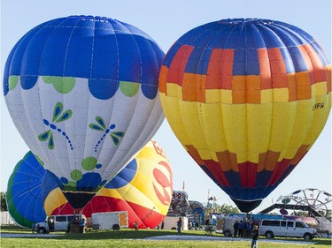 Hot air balloons are inflated before a morning flight over Gatineau Friday, August 29, 2014.