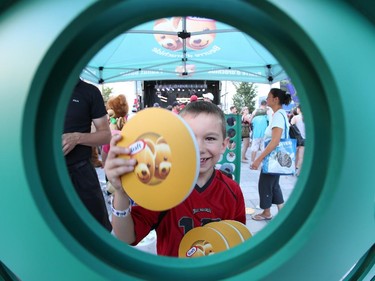 Jacob Taylor, 6, playes a giant  Connect 4 game during a family friendly event featuring TSN announcers during the Ottawa Redblacks and Calgary Stampeders match at TD Place in Ottawa on August 24, 2014.