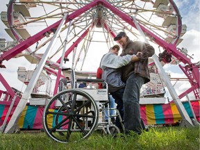 Jacques Desoto is helped into his chair by his care worker after enjoying a ride on the ferris wheel as the Capital Fair kicked off with Special Needs Day hosted by Hydro Ottawa.