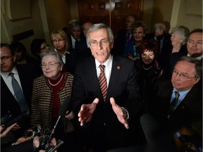 Sen. James Cowan addresses reporters outside the Senate in January, flanked by Sen. Joan Fraser (left) and Sen. Jim Munson (right) and the rest of the now-independent Senate Liberal group.